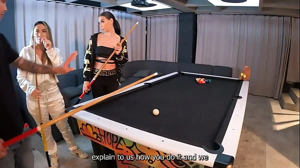 A threesome with two fiery Latinas on a pool table.