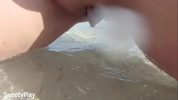 Shaved pussy peeing on public beach